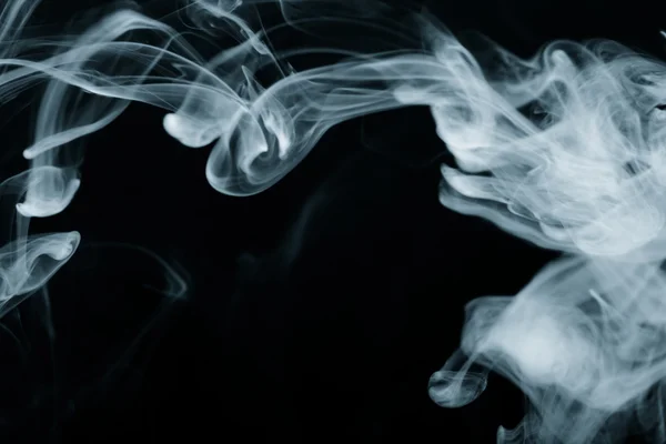 Cloud of smoke on black background. Selective focus. Toned — Stock Photo, Image