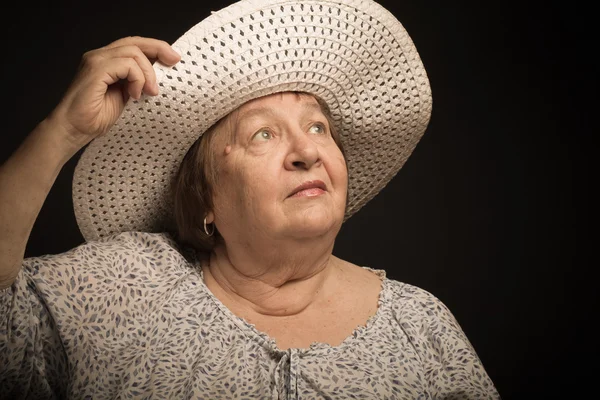 Portrait of elderly woman with a hat. Dream. Toned — Stock Photo, Image