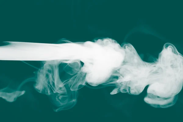 Cloud of smoke on black background. Selective focus. Toned — Stock Photo, Image