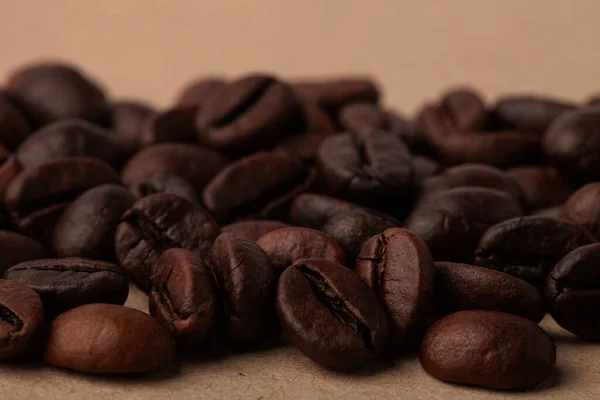 Roasted coffee beans on the light background for wallpaper or decor. Toned.