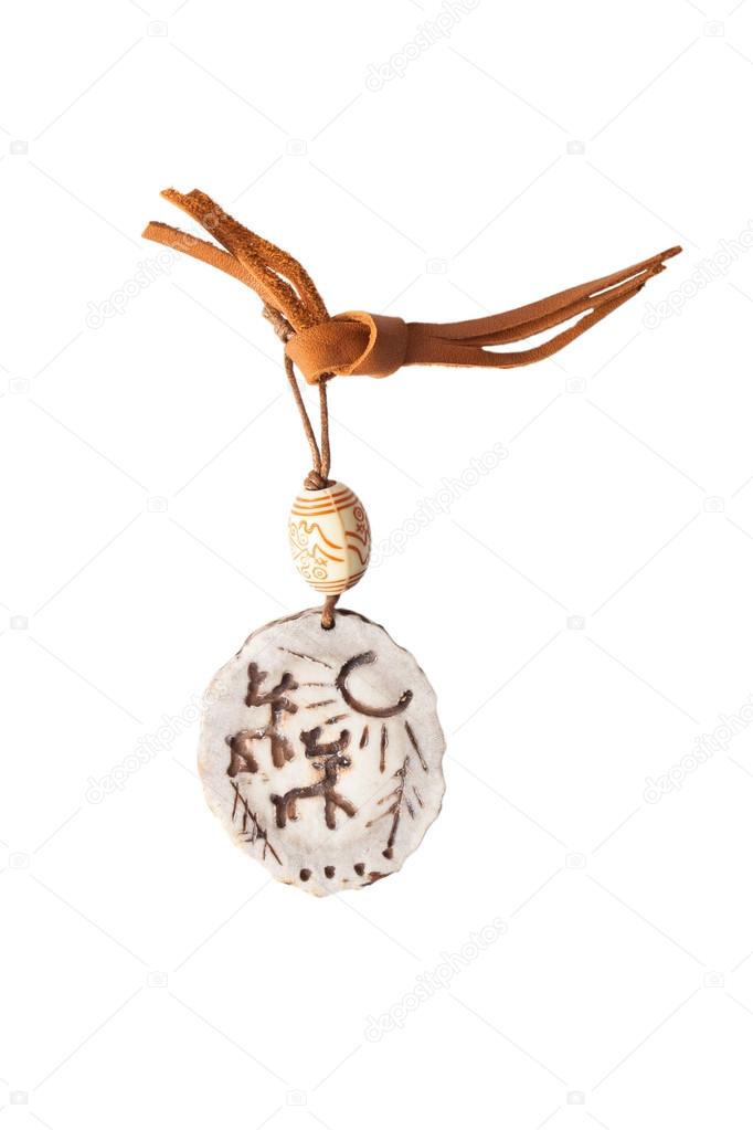 amulet of deer antlers on a leather strap, isolated on white bac