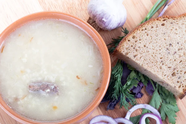 Soup kulesh of millet grains and meat with bread, garlic and herb — Stock Photo, Image