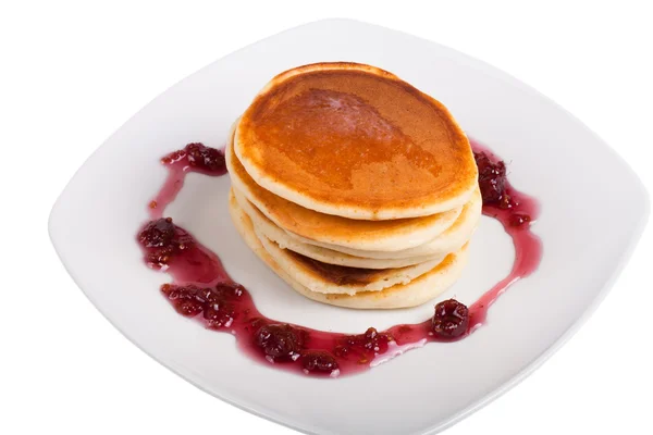 Pancakes with raspberry jam on a white plate isolated on white b — Stock Photo, Image