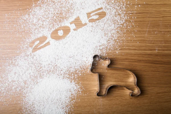 Inscription 2015 on flour and bear on a wooden table — Stock Photo, Image