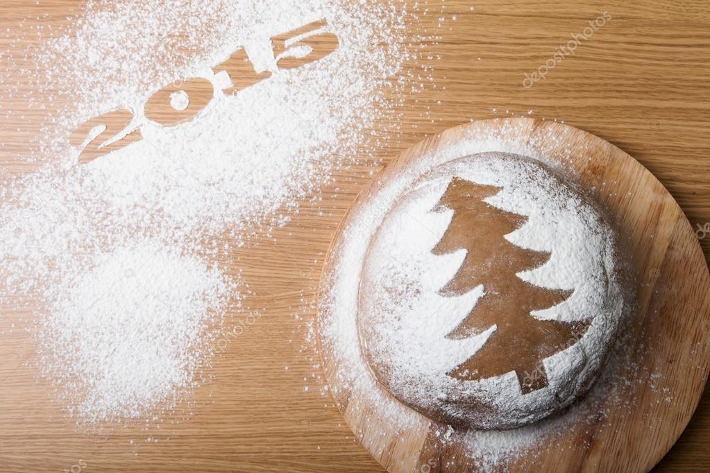 Inscription 2015 on flour and Dough patterned Christmas treeon a