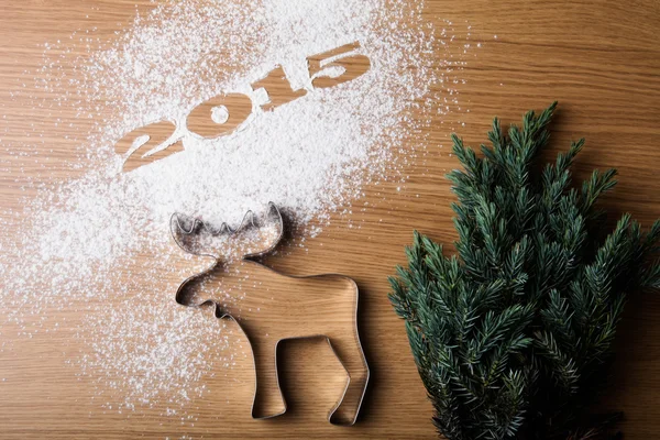 Inscription 2015 Christmas tree and form of moose on a wooden ta — Stock Photo, Image