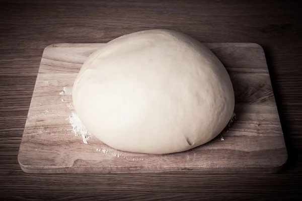 Dough on a board with flour. Tinted. — Stock Photo, Image