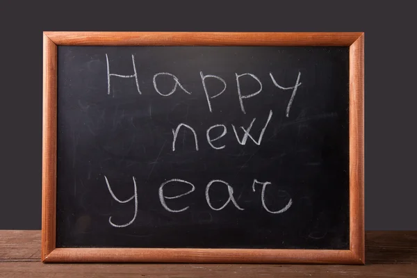 Inscription "Happy new year" in chalk on the blackboard — Stock Photo, Image