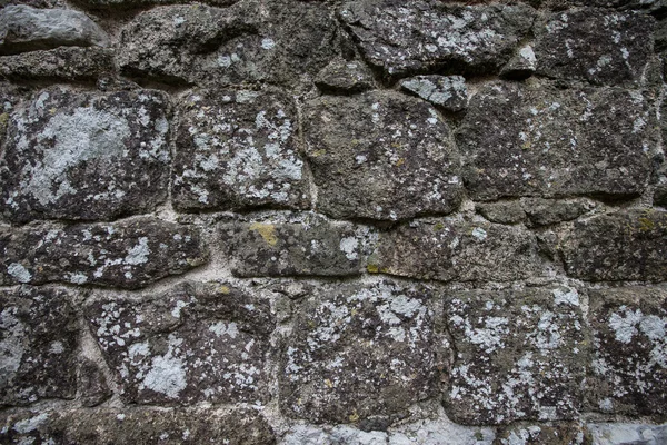 Wall of natural stone with lichen — Stock Photo, Image