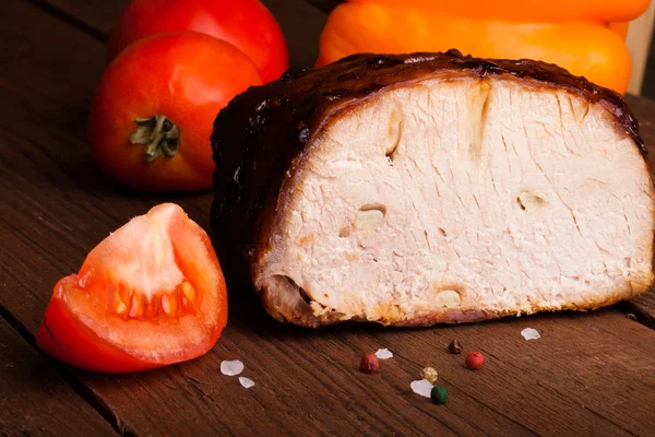 Pedaço de porco, pimentão e tomate em uma velha mesa de madeira — Fotografia de Stock