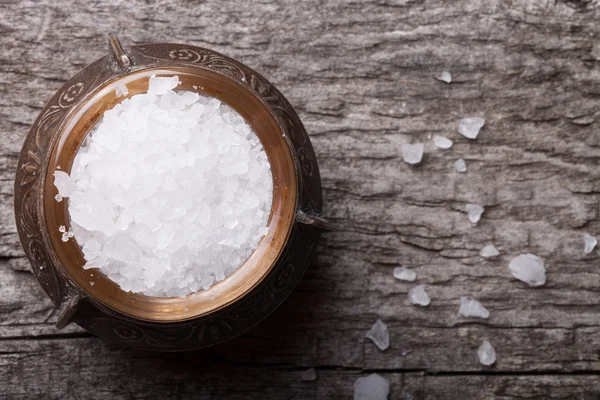 Sea salt in an old utensils on wooden table — Stock Photo, Image