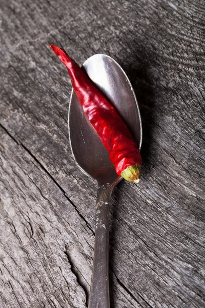 Red hot chili peppers in German silver spoon on old wooden table — Stock Photo, Image