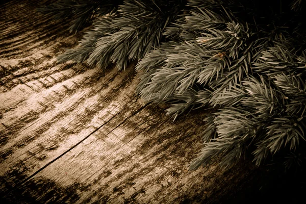 Christmas tree strewn on old wood. Tinted — Stock Photo, Image