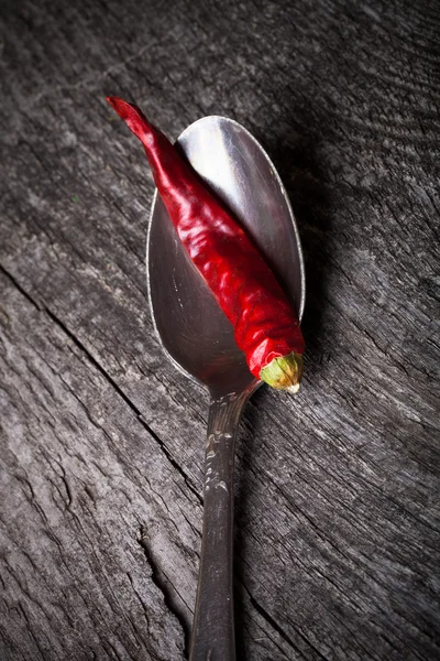 Red hot chili peppers in German silver spoon on old wooden table — Stock Photo, Image