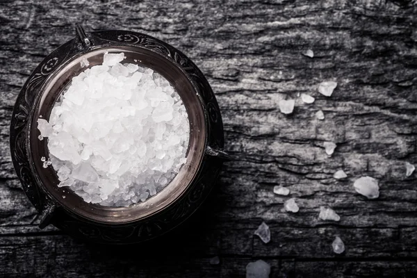 Sea salt in an old utensils on wooden table — Stock Photo, Image