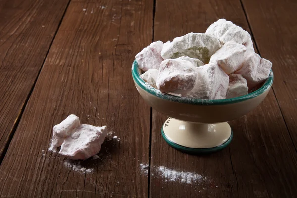 Turkish Delight in a ceramic vase on a wooden background — Stock Photo, Image