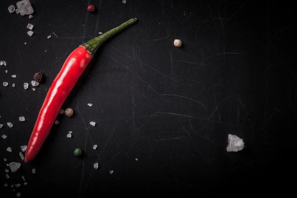 Red hot chili Pepper, coarse salt on the chalkboard with place f — Stock Photo, Image