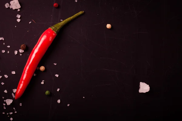 Red hot chili pepper, coarse salt on the chalkboard with place f — Stock Photo, Image