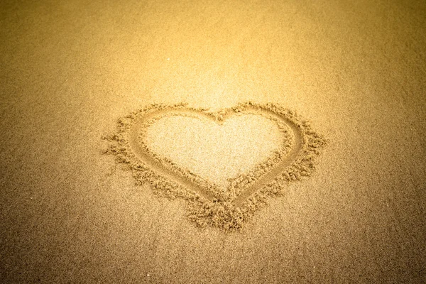 Heart drawn in the sand. Beach background. Tinted — Stock Photo, Image