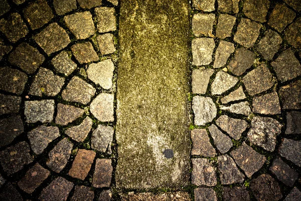 Old stone paving stones on the road — Stock Photo, Image