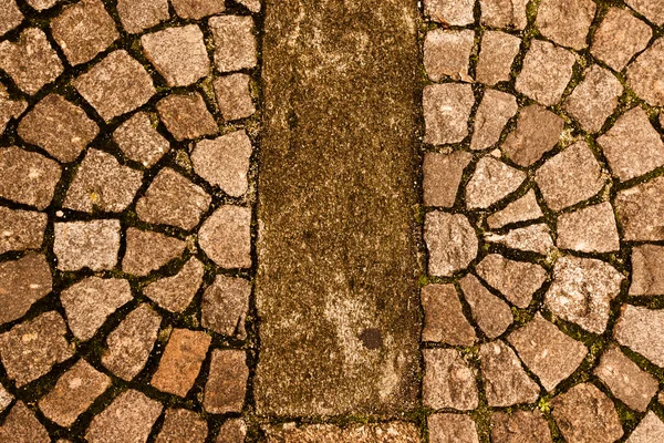 Old stone paving stones on the road — Stock Photo, Image