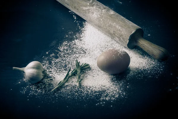 Massa de farinha em uma tábua com farinha. ovos, rolo de alfinete, alho — Fotografia de Stock