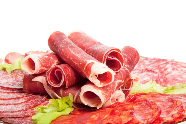 Slices of different kinds of meat with green salad — Stock Photo, Image