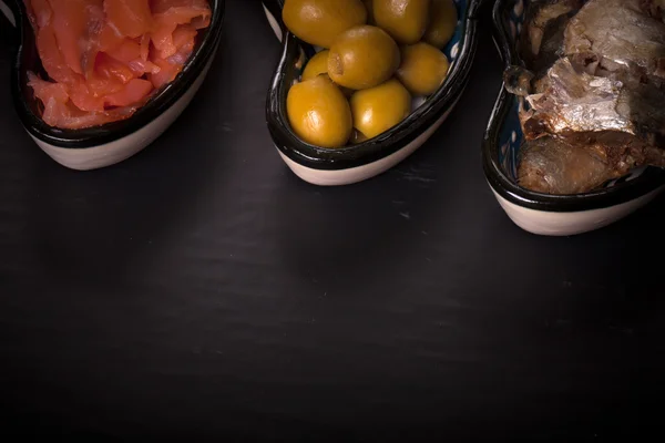 Variedade de peixes e azeitonas em prato oriental. Tonificado — Fotografia de Stock