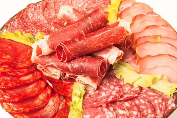 Slices of different kinds of meat with green salad. Toned — Stock Photo, Image