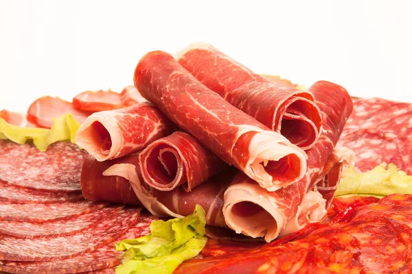 Slices of different kinds of meat with green salad. Toned — Stock Photo, Image