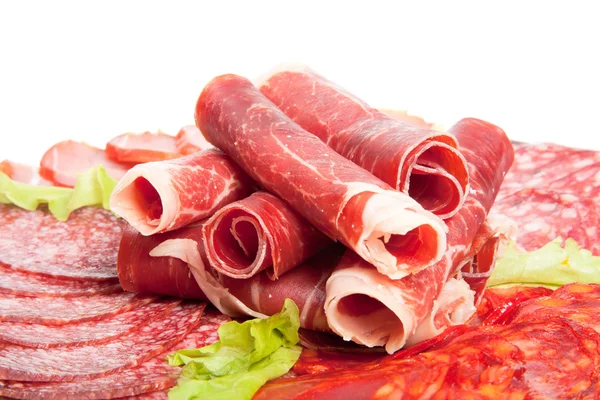 Slices of different kinds of meat with green salad — Stock Photo, Image