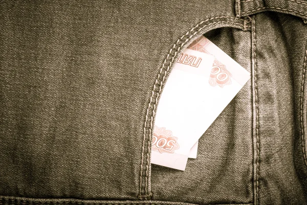 De zak van jeans met geld. Doek achtergrond. Afgezwakt — Stockfoto