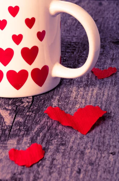Valentine hearts and cup of tea on the old wooden table. Toned — Stock Photo, Image