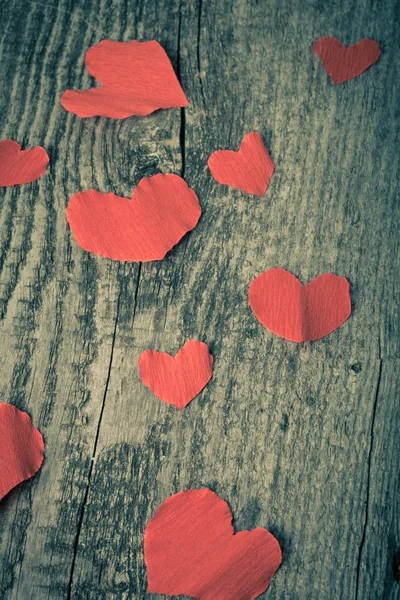 Many Valentine hearts on the old wooden table. Toned — Stock Photo, Image