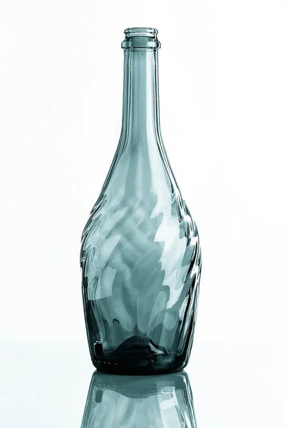 Empty carved glass bottle with reflection — Stock Photo, Image