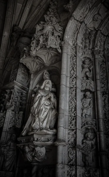 The wall of an old building with sculptures. Toned — Stock Photo, Image