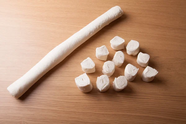 Pieces of dough on the wooden board — Stock Photo, Image