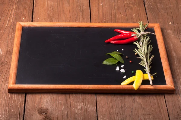 Herbs and spices. Red pepper, salt and rosmary on a black backgr — Stock Photo, Image