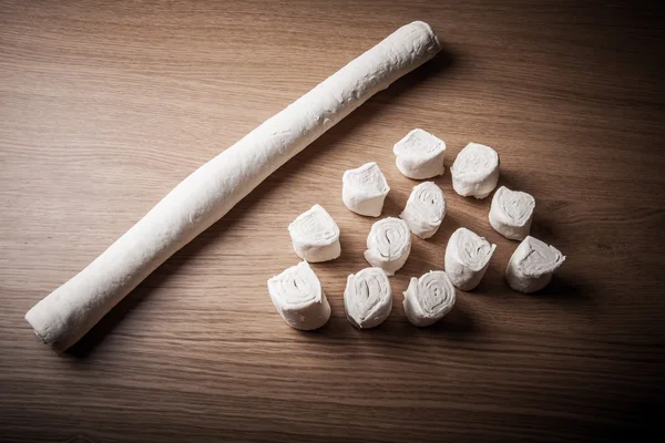 Pieces of dough on the wooden board. Toned — Stock Photo, Image