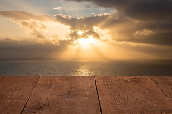 Wood flooring with a view of the sunset over the sea — Stock Photo, Image