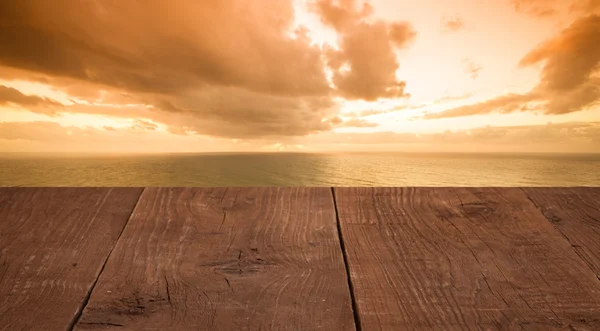 Wood flooring with a view of the sunset over the sea — Stock Photo, Image