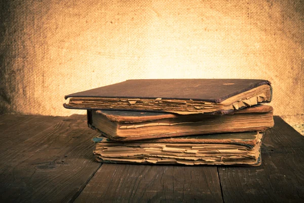 Stack of old books on the old wooden table. Toned — Stock Photo, Image