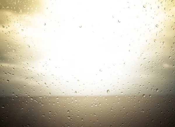 Seaview through the raindrops on window. Toned — Stock Photo, Image