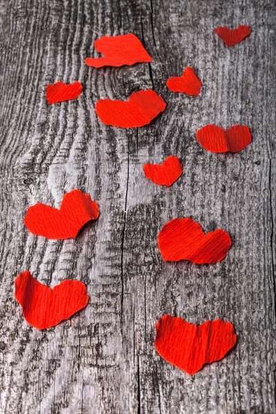 Many Valentine hearts on the old wooden table. — Stock Photo, Image