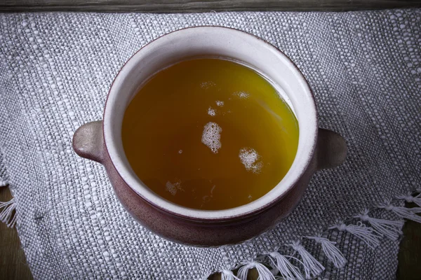 Clay pot with ghee on linen napkin. Rustic still life. Wooden ba — Stock Photo, Image