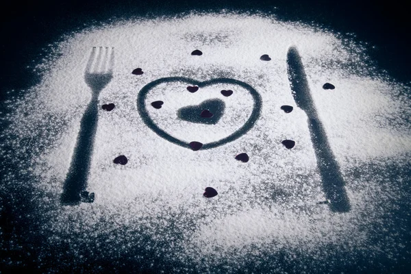 Silhouettes of fork, knife and hearts on the flour on a black ba — Stock Photo, Image