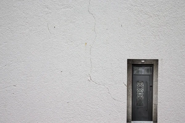 Porta metálica retro em uma parede rebocada leve — Fotografia de Stock