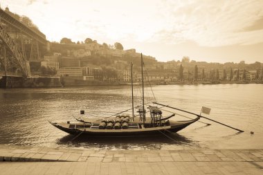Boat with barrels of wine at the berth. Douro River. city of Por clipart