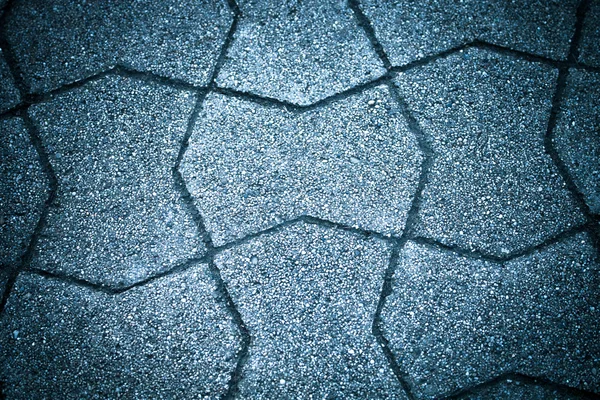 Sidewalk tile made of natural stones. Background. Toned — Stock Photo, Image