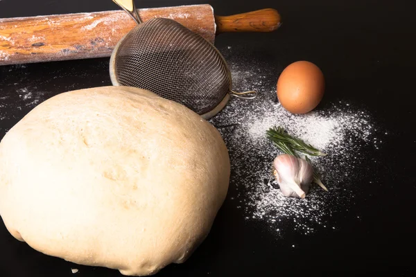 Flour, rolling pin, egg, rosemary, garlic and dough for pie — Stock Photo, Image